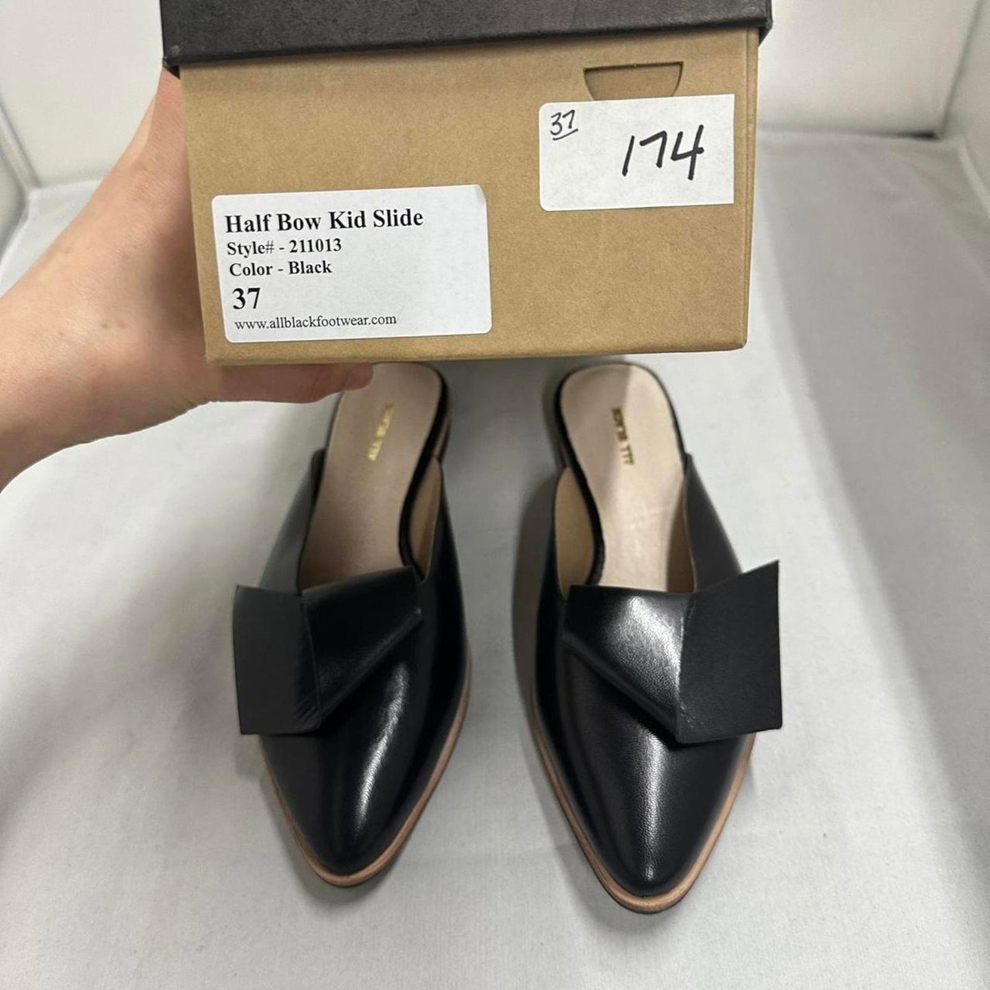 Contemporary Chic Black Leather Half Bow Mule Slides (6.5)