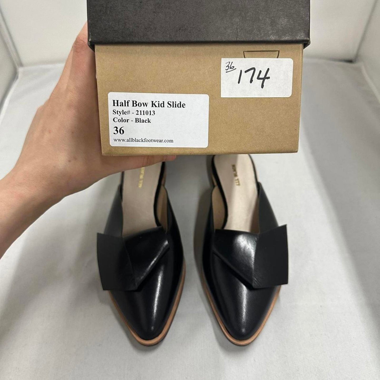 Contemporary Chic Black Leather Half Bow Mule Slides (5.5)