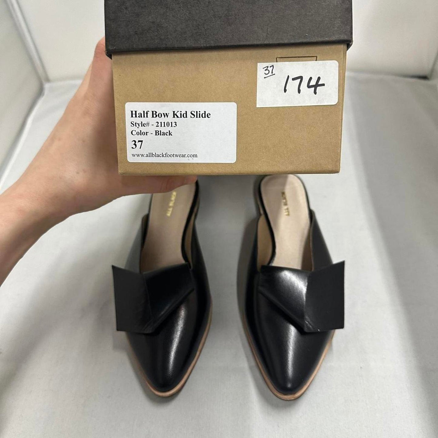 Contemporary Chic Black Leather Half Bow Mule Slides (6.5)